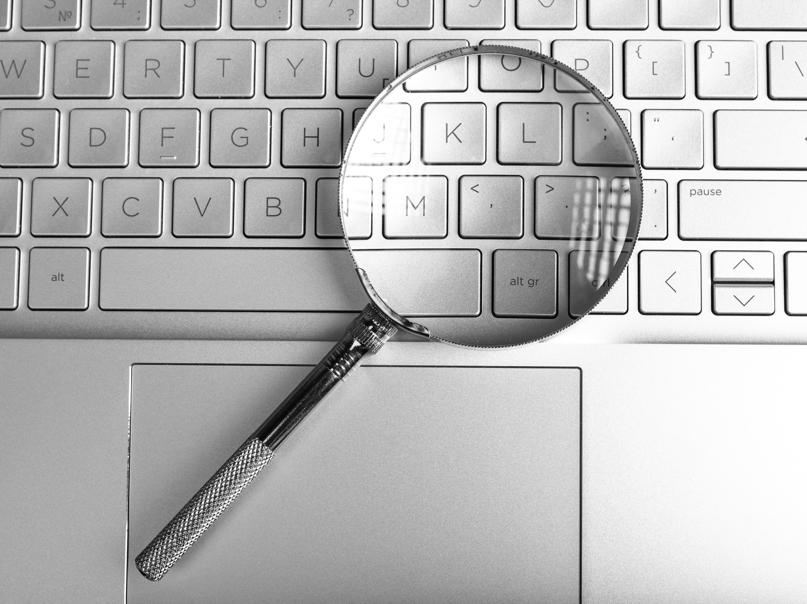 Loupe posée sur le clavier d'un ordinateur portable